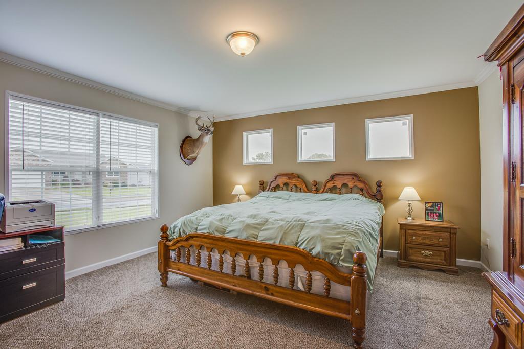 1142 Wrights Mill Road Spring Hill, TN 37174 - Photo 15 of 30 a bed sitting in a bedroom next to a window