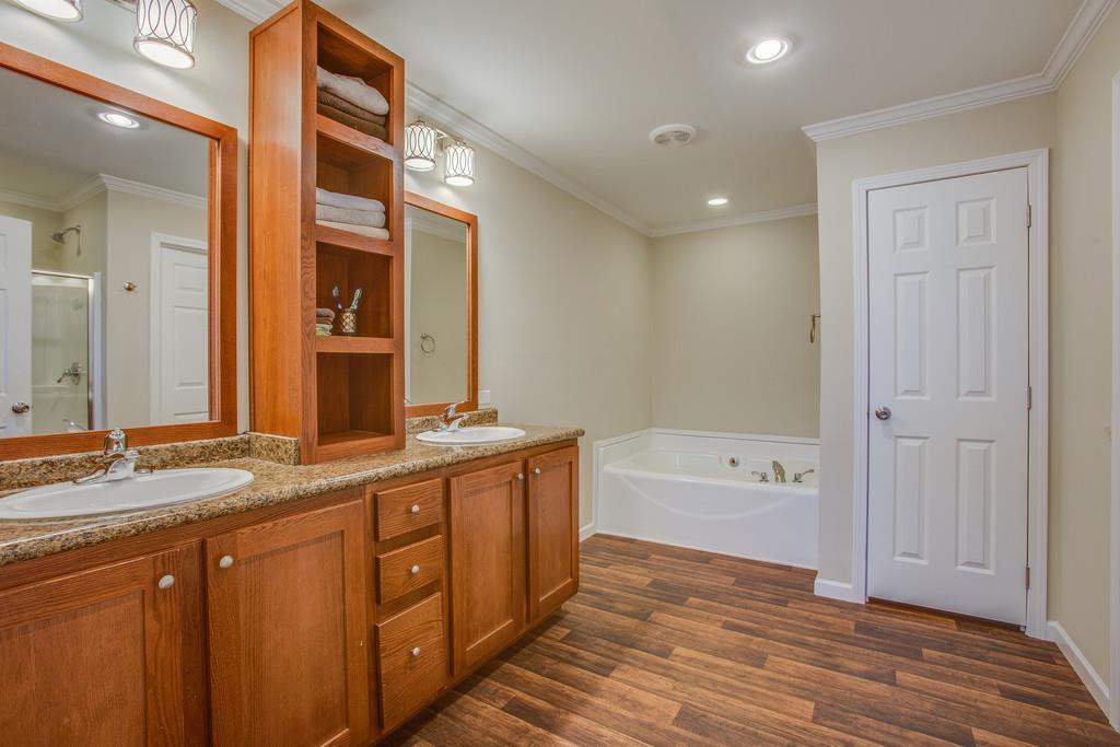 1142 Wrights Mill Road Spring Hill, TN 37174 - Photo 17 of 30 a spacious bathroom with a granite countertop sink mirror and bathtub