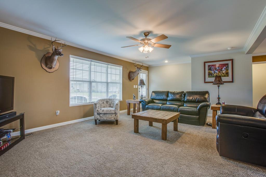 1142 Wrights Mill Road Spring Hill, TN 37174 - Photo 8 of 30 a living room with furniture a chandelier and a window