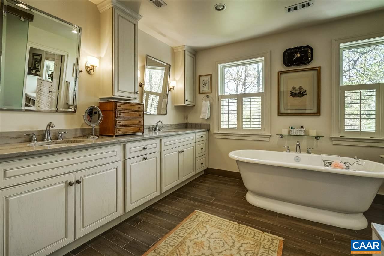 2845 Ridge Road Charlottesville, VA 22901 - Photo 40 of 50 a spacious bathroom with double vanity sink a two mirror a window a bathtub and vanity