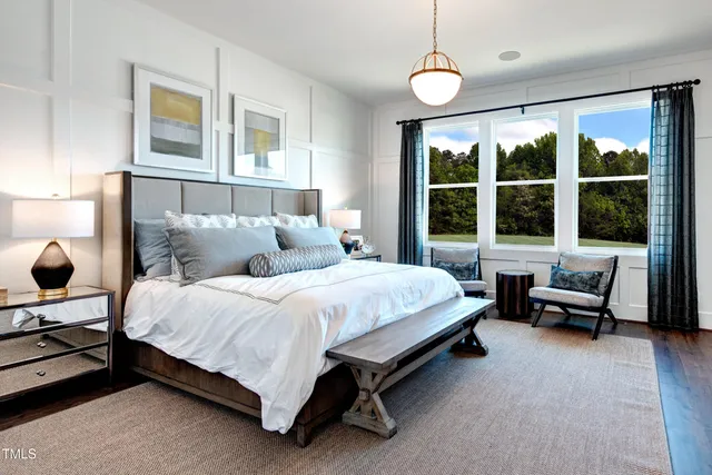 a bedroom with a bed chair and window