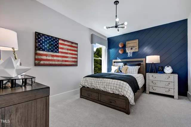 a spacious bedroom with a bed and a chandelier