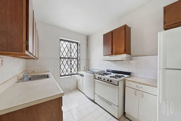 a kitchen that has a sink and a stove