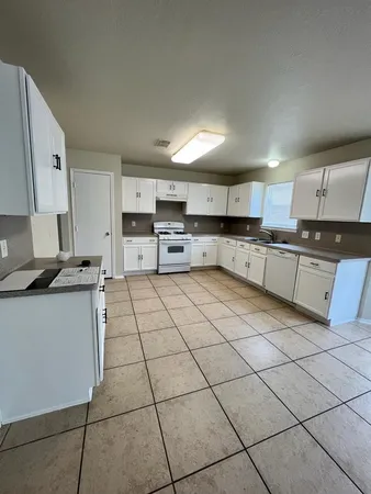 a kitchen with stainless steel appliances granite countertop a sink and cabinets