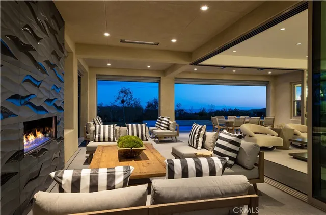 a living room with furniture and large windows