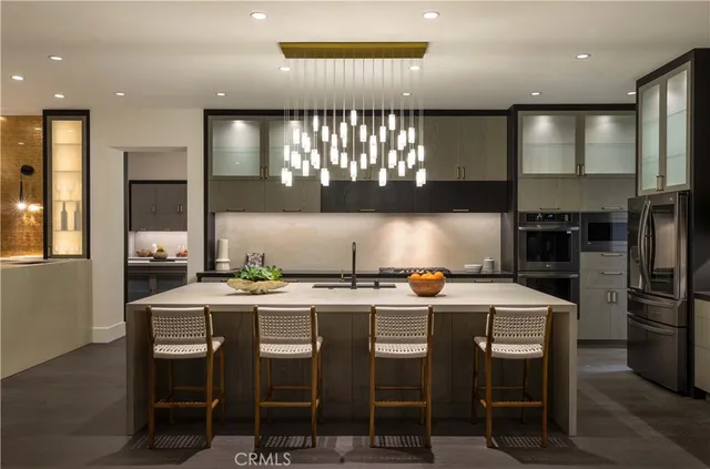 a kitchen with a dining table chairs stainless steel appliances and cabinets