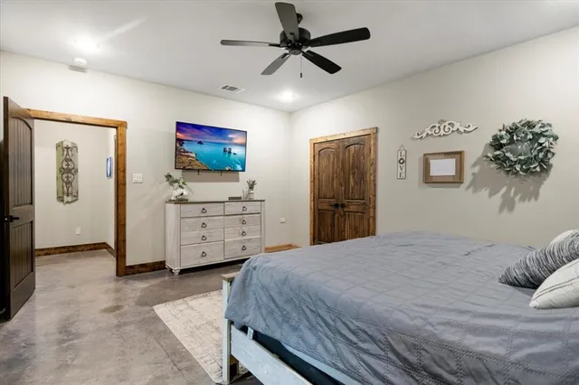 a bedroom with a bed and a flat tv screen on the wall