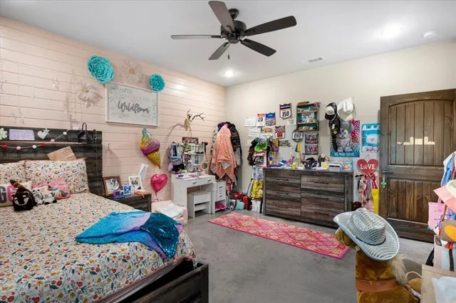 a bedroom with bed and a chandelier