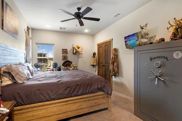 a bedroom with a large bed and a chandelier