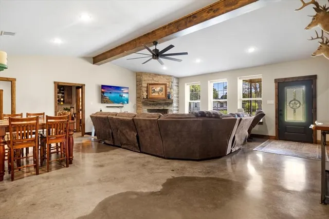 a living room with furniture a dining table and chairs