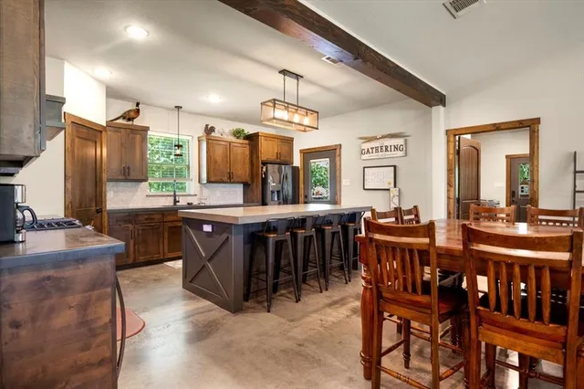 a kitchen with a table and chairs in it