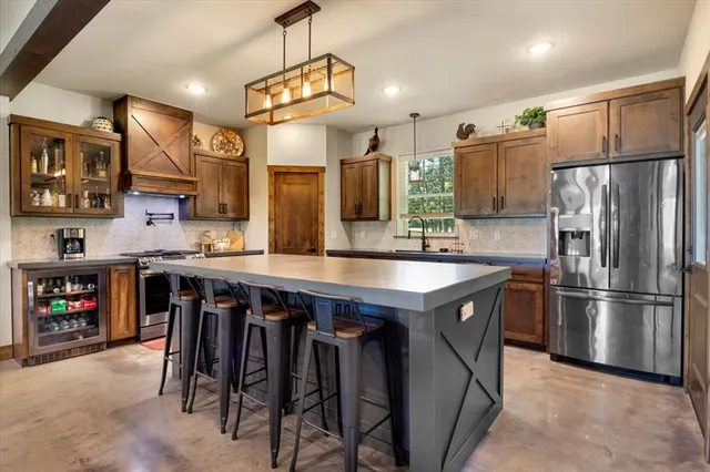 a kitchen with kitchen island a wooden floor and refrigerator