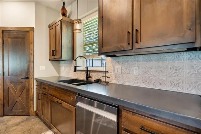 a kitchen with stainless steel appliances granite countertop a sink a microwave cabinets and a counter space