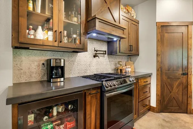 a kitchen with stainless steel appliances granite countertop a stove and a microwave