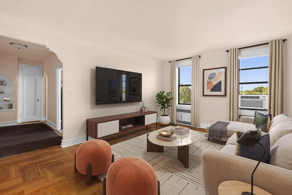 a living room with furniture wooden floor and window