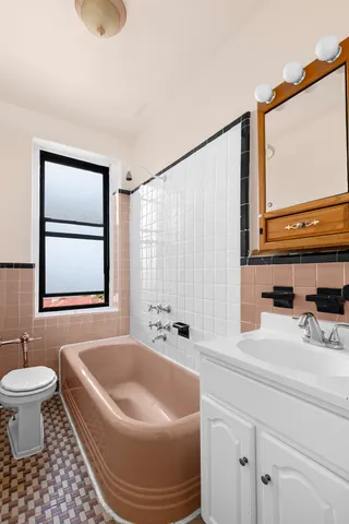 a bathroom with a sink a toilet and a mirror