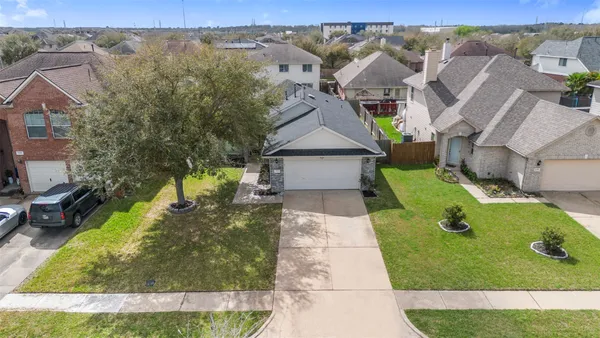 an aerial view of a house with a garden and pool