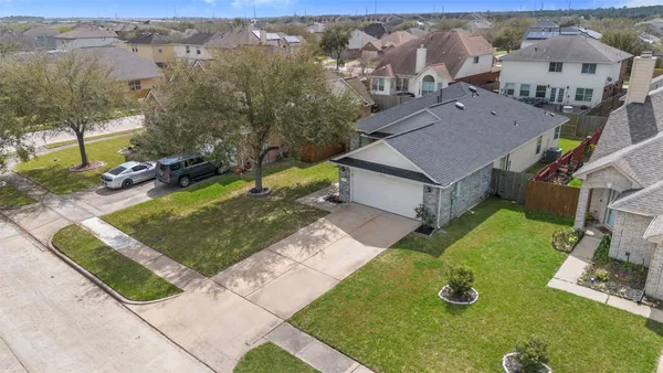 an aerial view of a house with yard