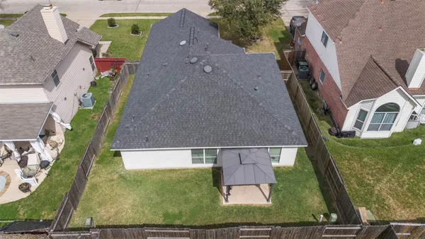 an aerial view of a house with a yard