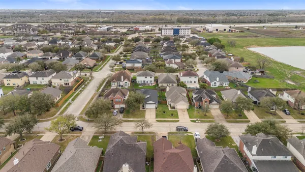 an aerial view of residential houses with outdoor space