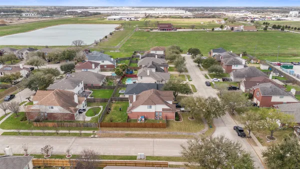 an aerial view of residential building with outdoor space and ocean view