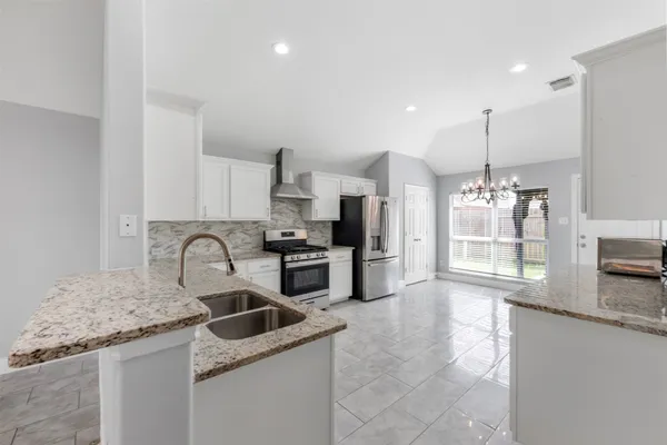 a kitchen with refrigerator and cabinets