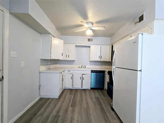 a kitchen with a refrigerator a sink and dishwasher