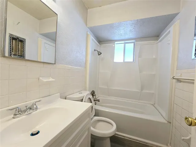 a bathroom with a sink a toilet and a bathtub