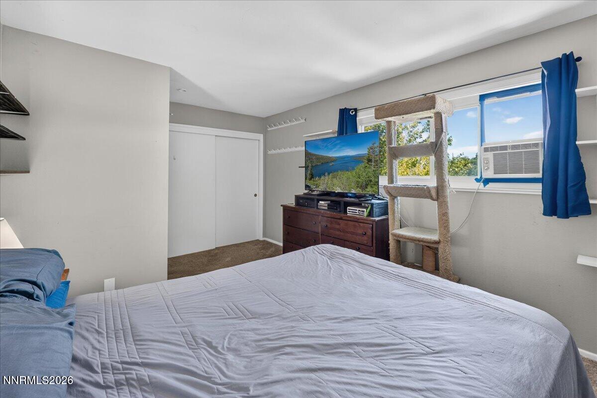 5 Smithridge Park Reno, NV 89502 - Photo 15 of 24 a bedroom with a bed and a flat tv screen on dresser