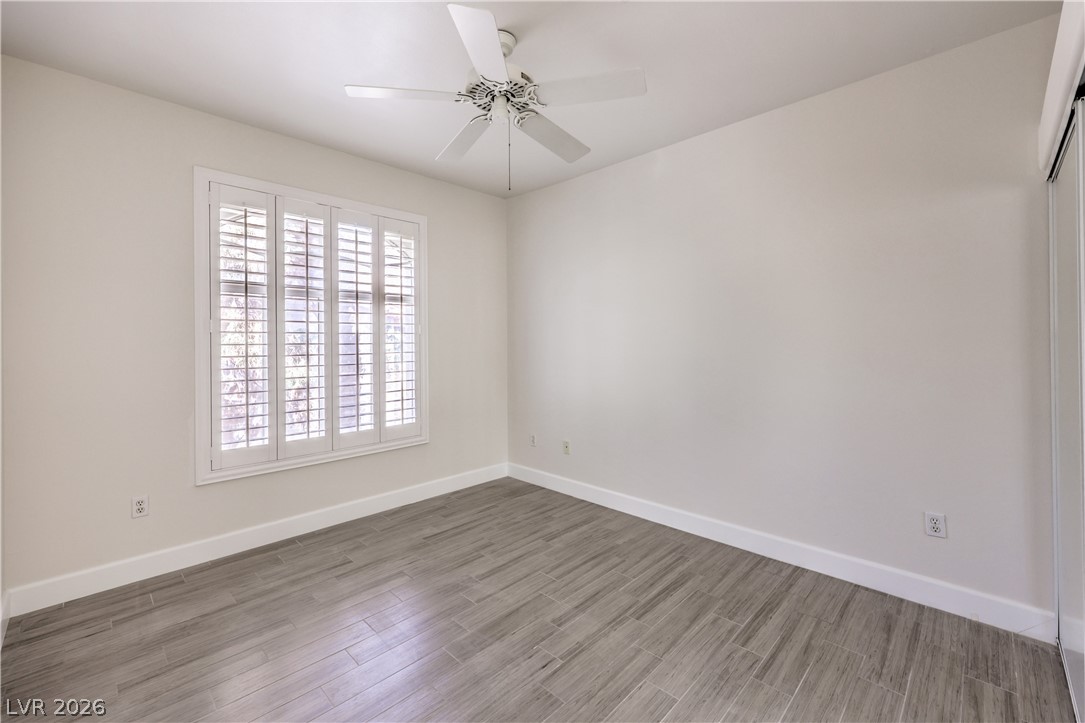 2050 West Warm Springs Road, Unit 1421 Henderson, NV 89014 - Photo 31 of 45 A well-lit room featuring large windows with louvered shutters and sleek wood-look tile flooring.