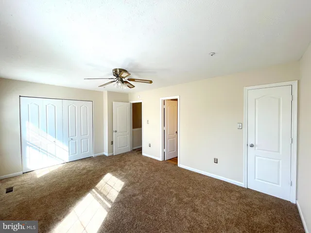 a view of a livingroom with a ceiling fan and window