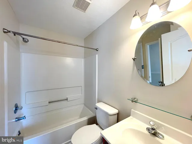 a bathroom with a toilet sink and shower