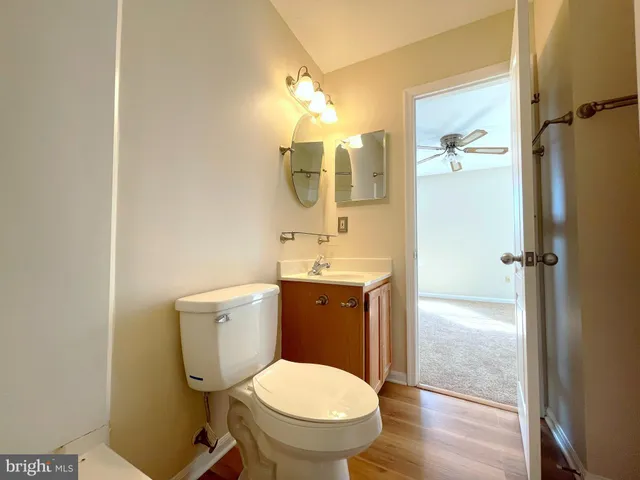 a bathroom with a toilet sink and a mirror