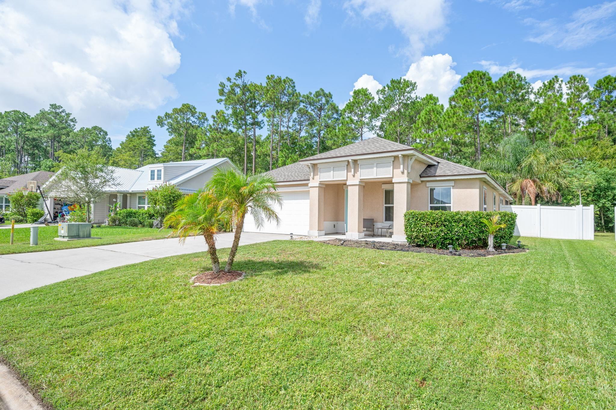 509 Deer Crossing Road St. Augustine, FL 32086 - Photo 2 of 54 a front view of a house with garden