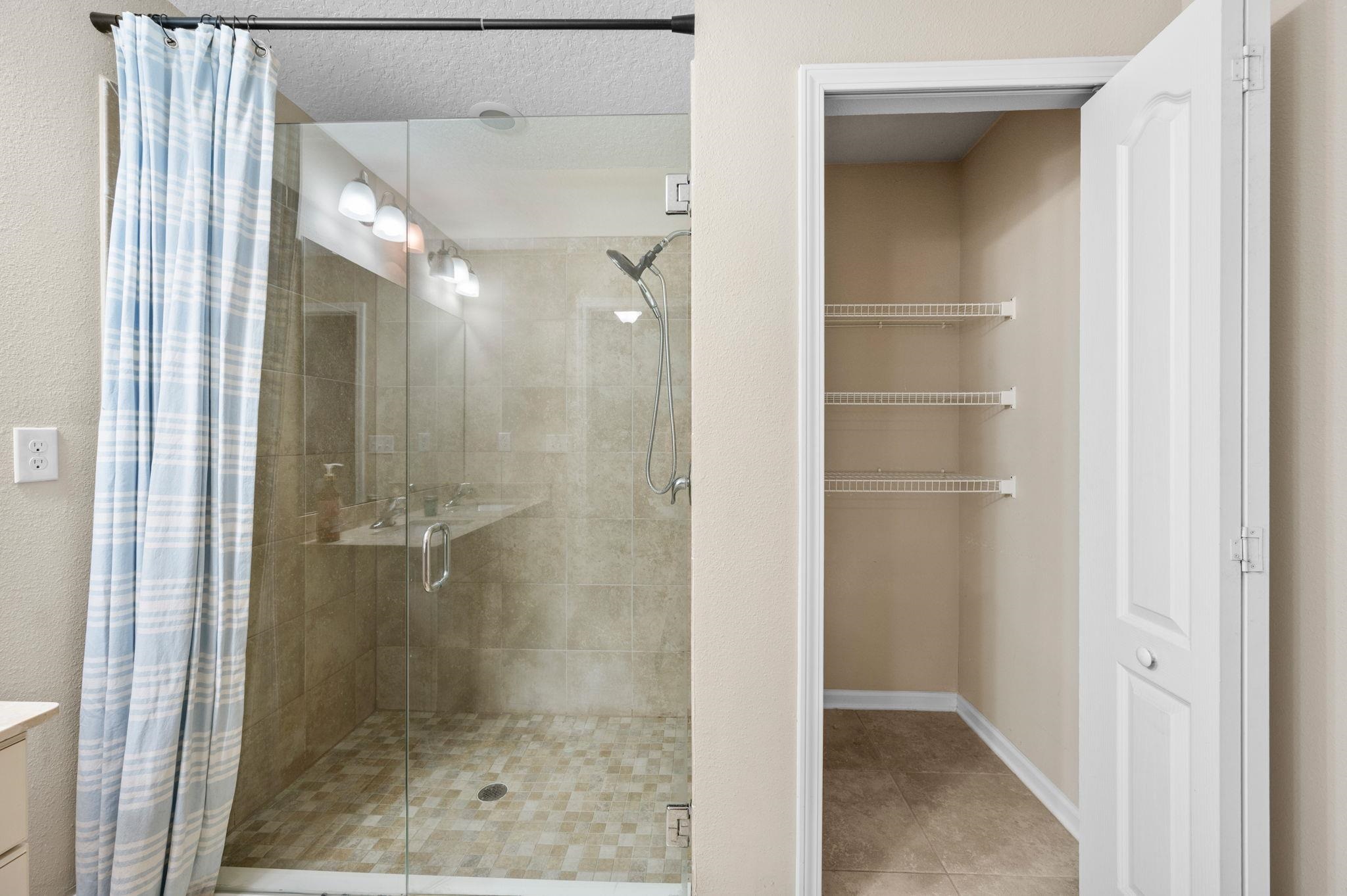 509 Deer Crossing Road St. Augustine, FL 32086 - Photo 23 of 54 a bathroom with a glass shower door