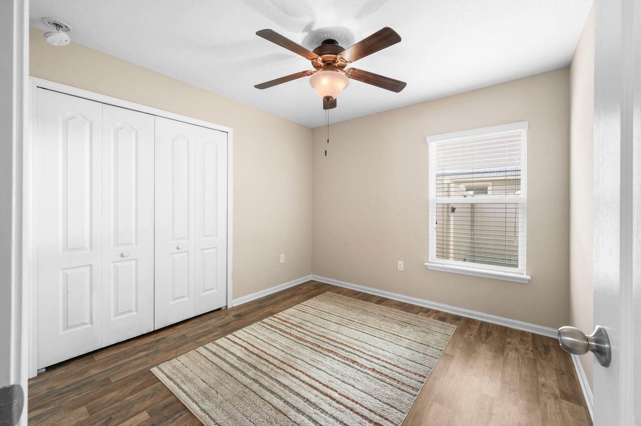 509 Deer Crossing Road St. Augustine, FL 32086 - Photo 27 of 54 wooden floor in an empty room with a window