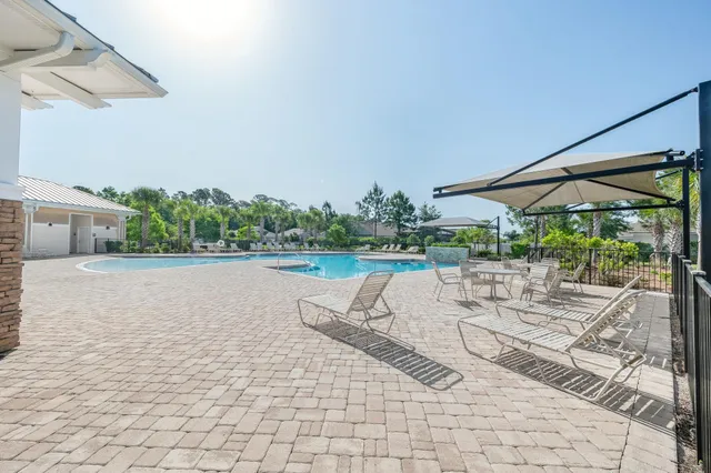 a view of a dining room with furniture large windows and wooden floor