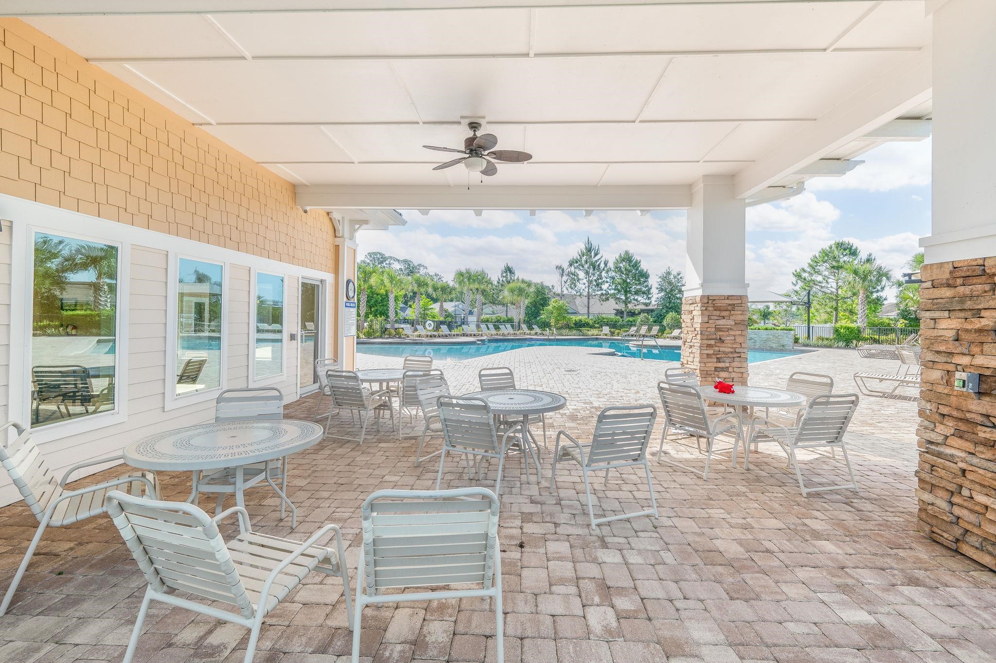 509 Deer Crossing Road St. Augustine, FL 32086 - Photo 49 of 54 a view of a dining room with furniture large windows and wooden floor