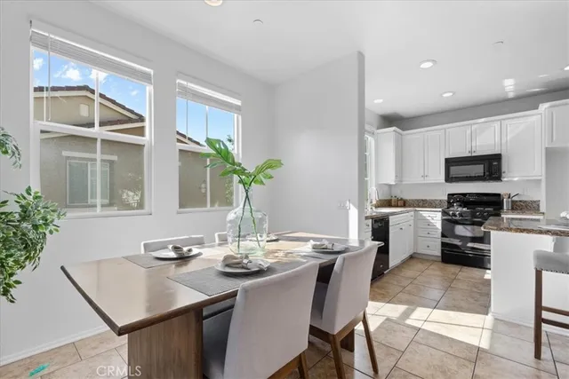 a kitchen with granite countertop kitchen island white cabinets and stainless steel appliances