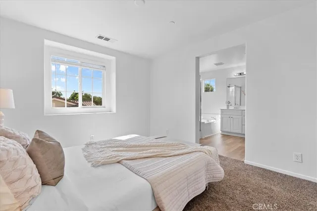 a bedroom with a bed and a painting on the wall