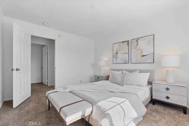 a bedroom with a bed and a couch