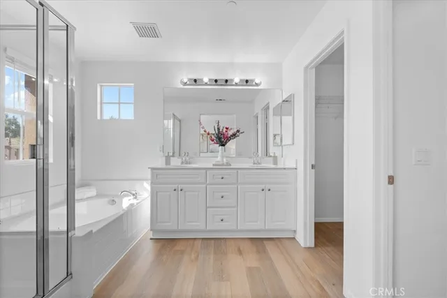 a spacious bathroom with a granite countertop tub sink and mirror