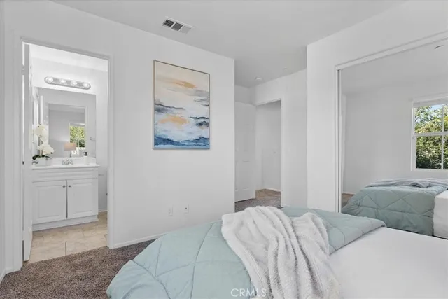 a bedroom with a bed and a couch