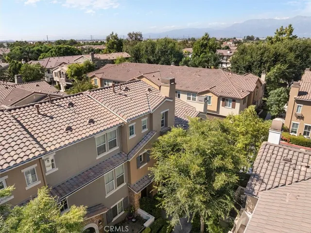 an aerial view of multiple houses with a yard