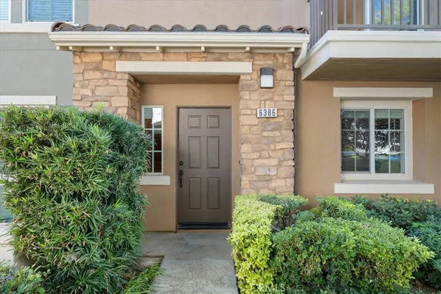 front view of a house with potted plants