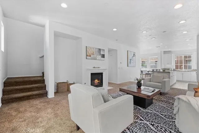 a living room with furniture a fireplace and a table