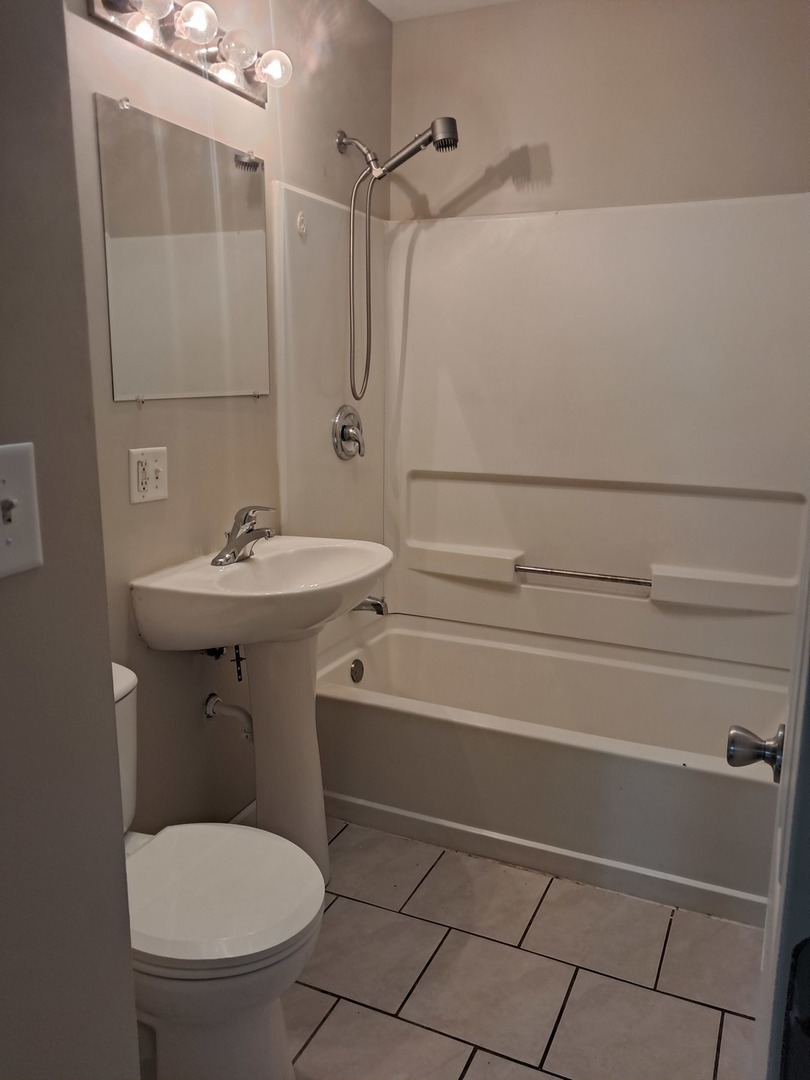 303 North Division Street Braidwood, IL 60408 - Photo 12 of 20 a bathroom with a sink toilet and shower