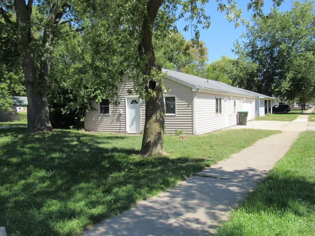 a front view of house with a garden