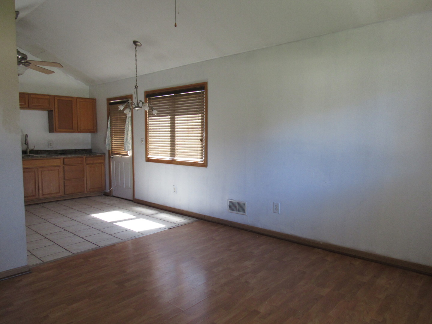 303 North Division Street Braidwood, IL 60408 - Photo 4 of 20 an empty room with chandelier fan and windows