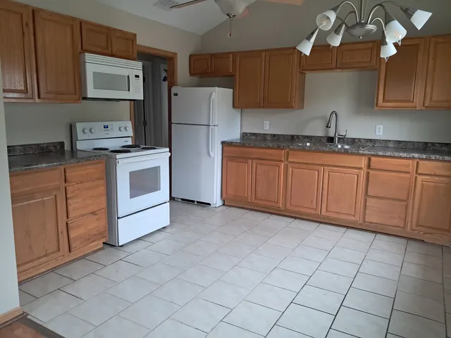 a kitchen with granite countertop cabinets and sink
